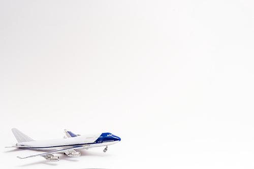 small toy plane on white with copy space