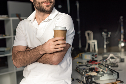 cropped image of man holding cup of coffee