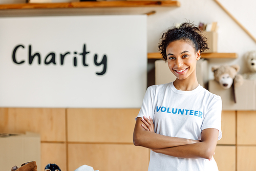 attractive african american volunteer girl standing with crossed arms and 