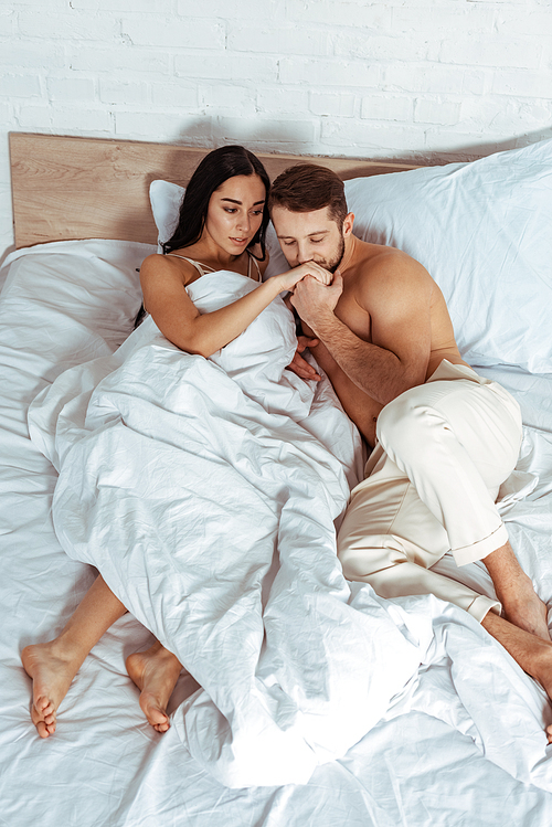 handsome man  hand of beautiful woman in bedroom