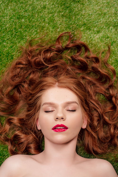 top view of beautiful young redhead woman with red lips and eyes closed