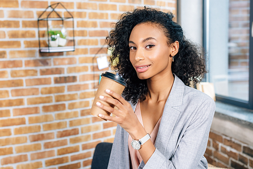 beautiful african american Casual businesswoman with coffee to go  in office