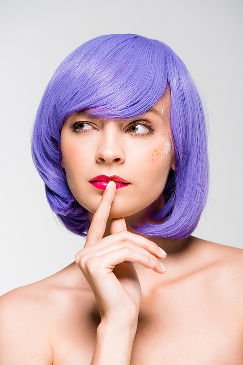 pensive naked girl in purple wig isolated on grey