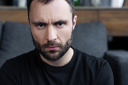 serious handsome bearded man in black t-shirt 