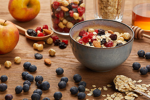 berries, nuts and muesli for breakfast on wooden table