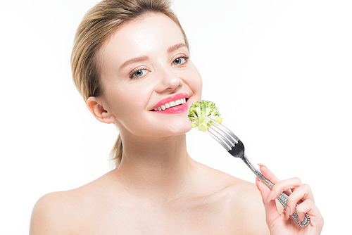 happy naked woman holding fork with green ripe broccoli isolated on white