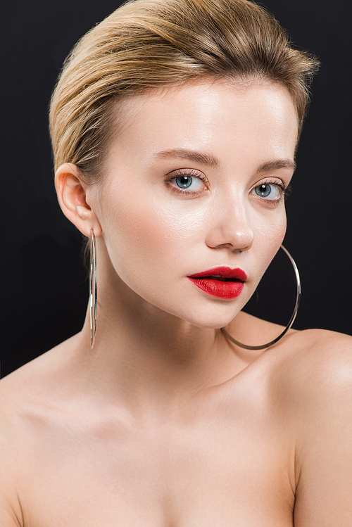 attractive naked woman in earrings  isolated on black