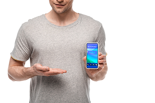 cropped view of man presenting smartphone with booking app, isolated on white