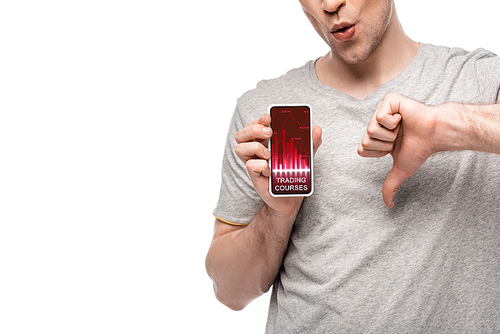 cropped view of man showing thumb down and smartphone with trading courses app, isolated on white