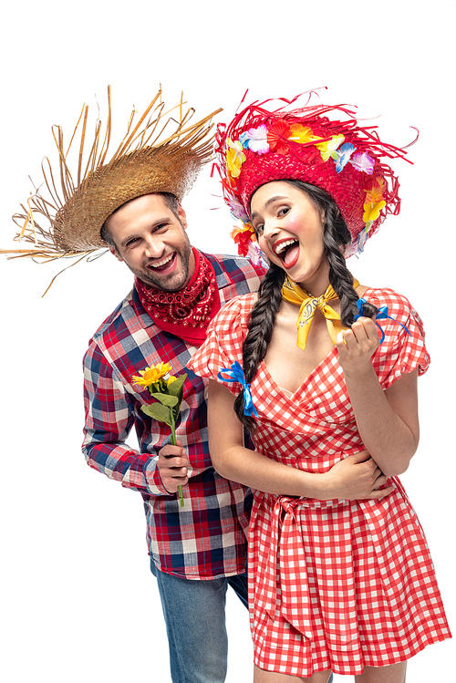 cheerful man and young woman in festive clothes with sunflower isolated on white