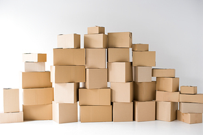 brown cardboard boxes stacked on each other on white