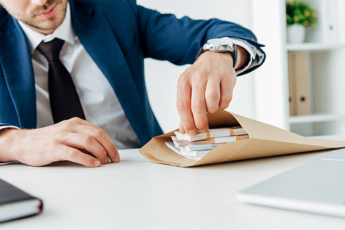 cropped view of businessmen near contract and pen on table