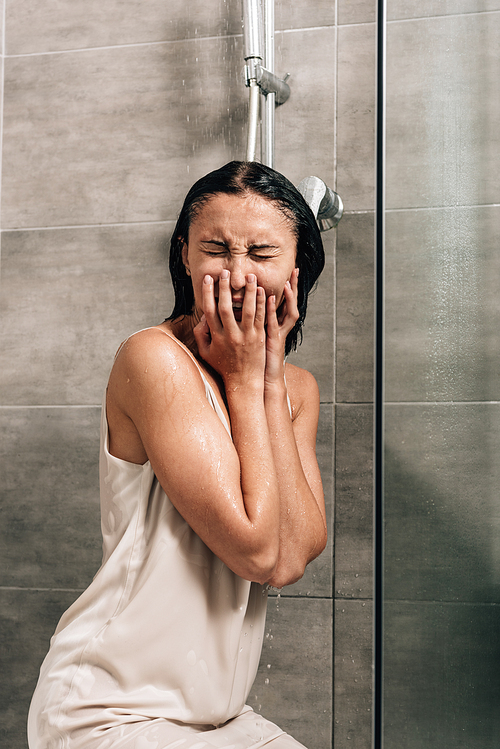 lonely frustrated woman crying in shower at home