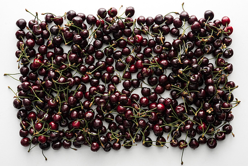 top view of sweet and ripe cherries on white background