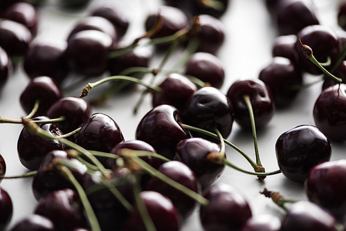 selective focus of ripe, fresh, whole and sweet cherries