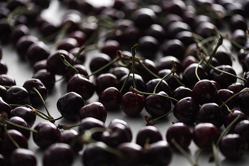 selective focus of ripe, fresh, whole and sweet cherries