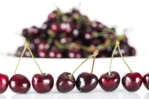 selective focus of red, fresh, whole and sweet cherries