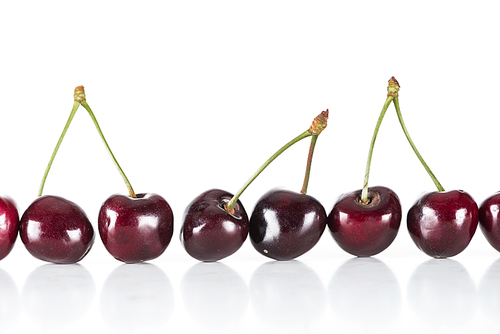 red, fresh, whole and sweet cherries on white background with copy space