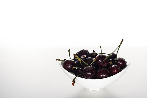 fresh, sweet and ripe cherries covered with water drops on bowl