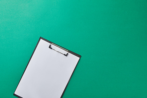 top view of folder with empty paper isolated on green