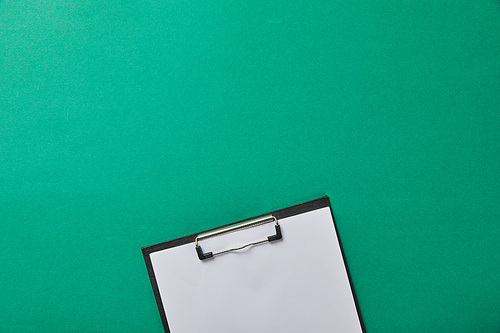 folder with blank paper isolated on green