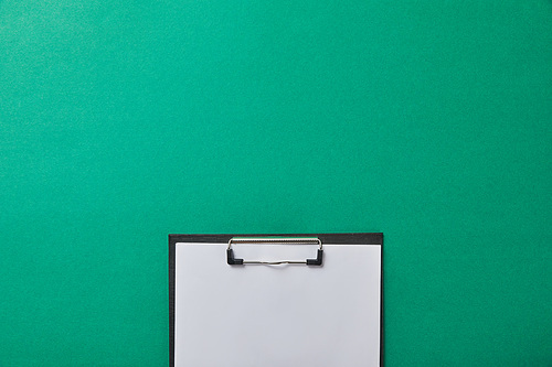 top view of folder with blank paper isolated on green isolated on green