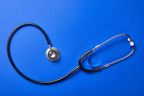 top view of stethoscope on blue background