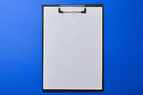 top view of folder with blank paper isolated on blue