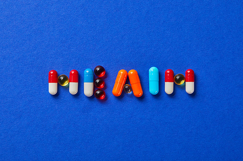 top view of word health made from various pills on blue background