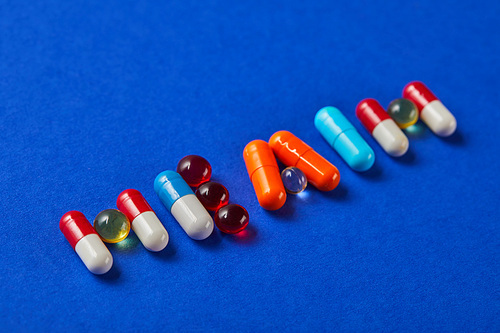 word health made from various pills on blue background