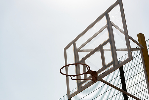 basketball hoop at basketball court under sky in sunny day