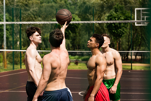 four sexy shirtless basketball players training at basketball court