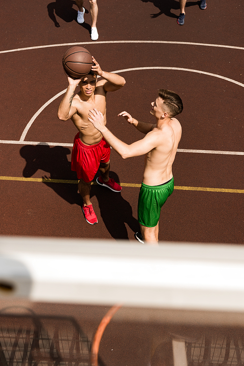overhead view of basketball players with ball at basketball court
