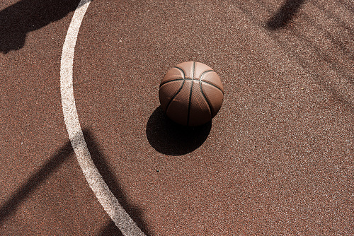 ball on brown playing surface at basketball court