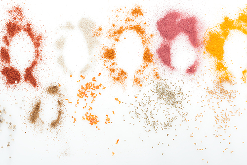 top view of various colorful spices on white background