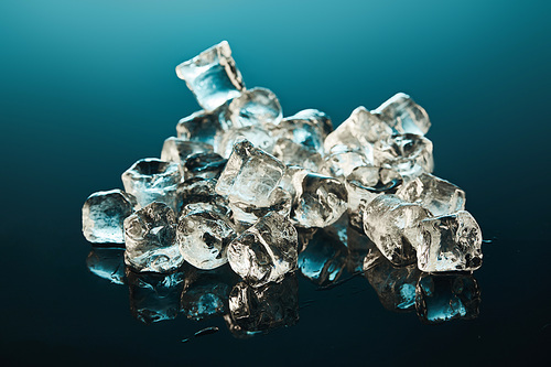 stack of transparent ice cubes on emerald background