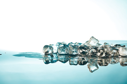 pure melting ice cubes on emerald and white background