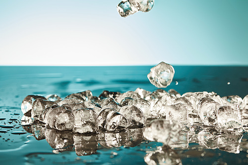 melting ice cubes on emerald and white background