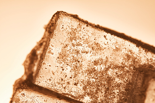 textured transparent ice cube on illuminated background