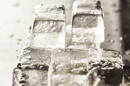 close up view of transparent wet textured ice cubes