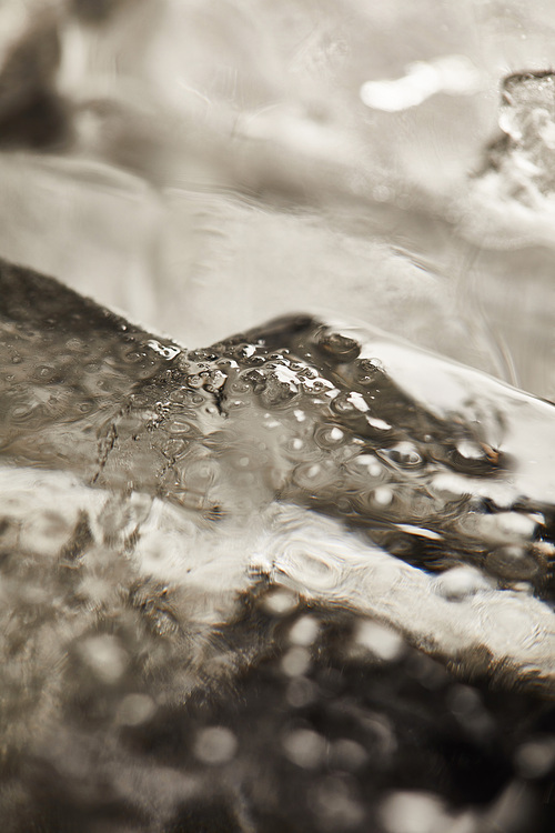 close up view of  transparent wet textured ice cubes