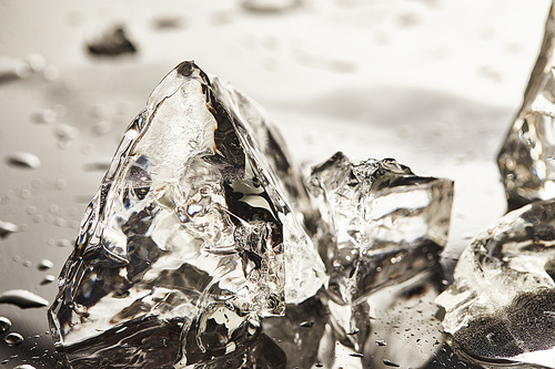 close up view of pure melting ice cubes with drops