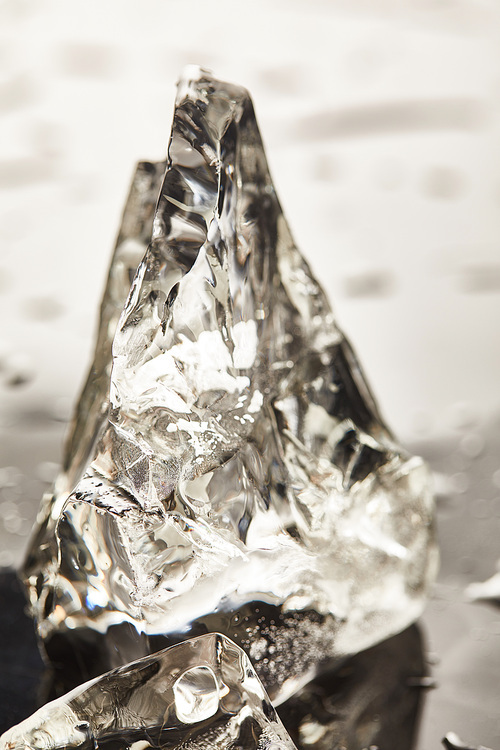 close up view of pure melting ice cube with drops