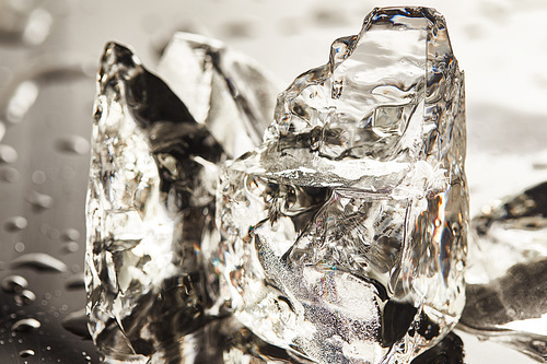 close up view of pure melting ice cubes with drops