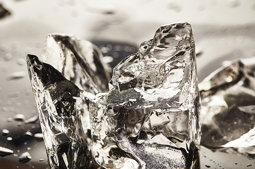 close up view of pure melting ice cubes with drops