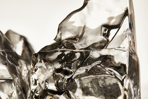 close up view of transparent ice cubes isolated on grey