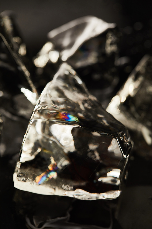 close up view of transparent ice cube with reflection