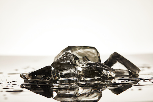 stack of melted transparent ice cubes on white background