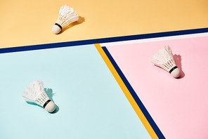 Badminton shuttlecocks on colorful background with blue lines
