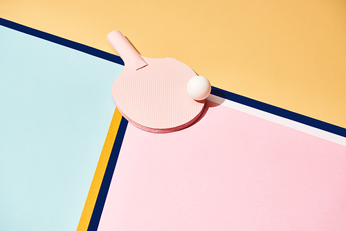 Table tennis racket and ball on colorful background with lines